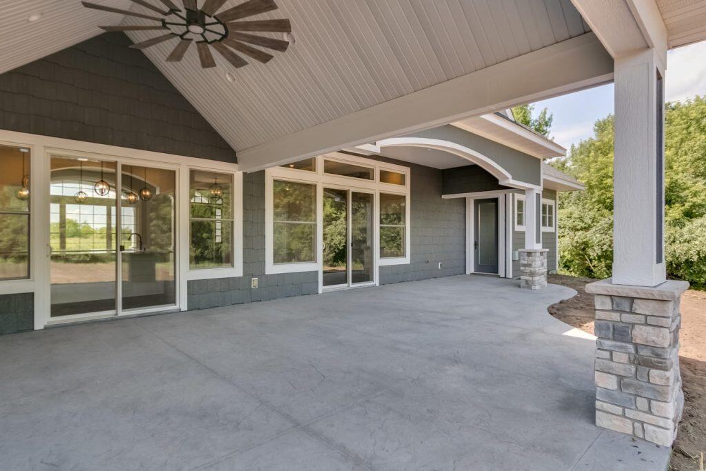 Modern concrete patio with covered outdoor living space and scenic views.