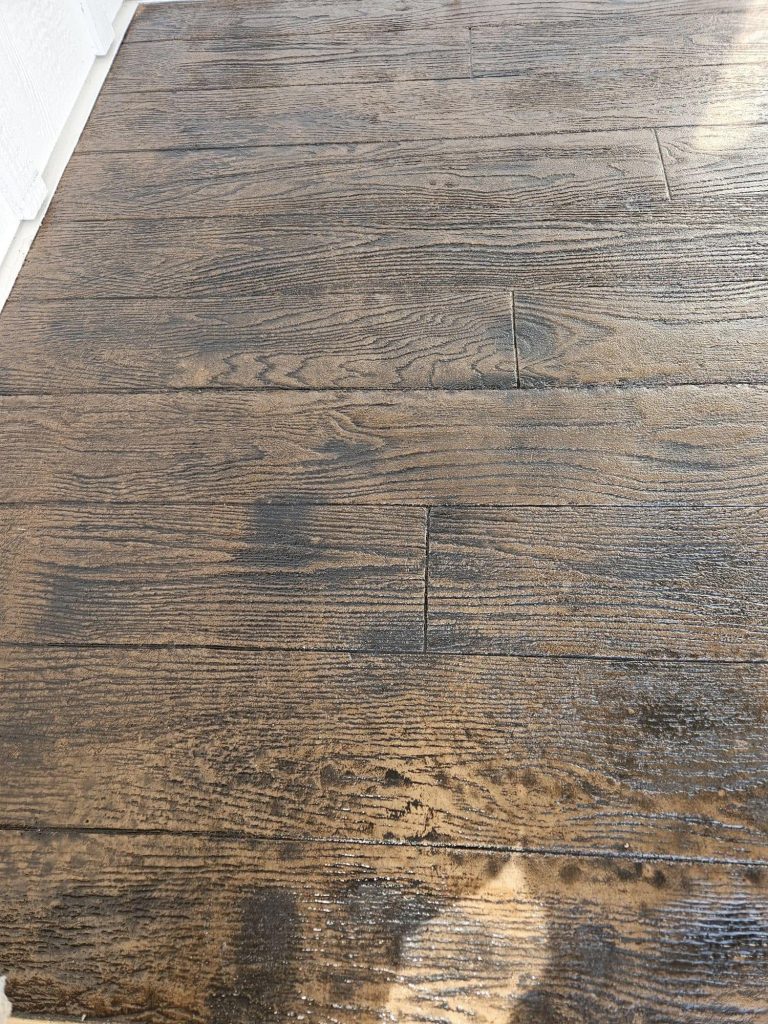 A lush, stained wood-look concrete floor with a rich, warm finish in a modern project setting.
