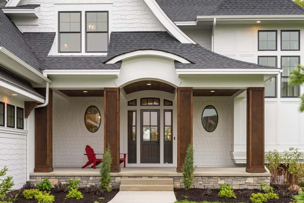 A modern residential porch with concrete steps and decorative columns, part of a custom concrete pro.