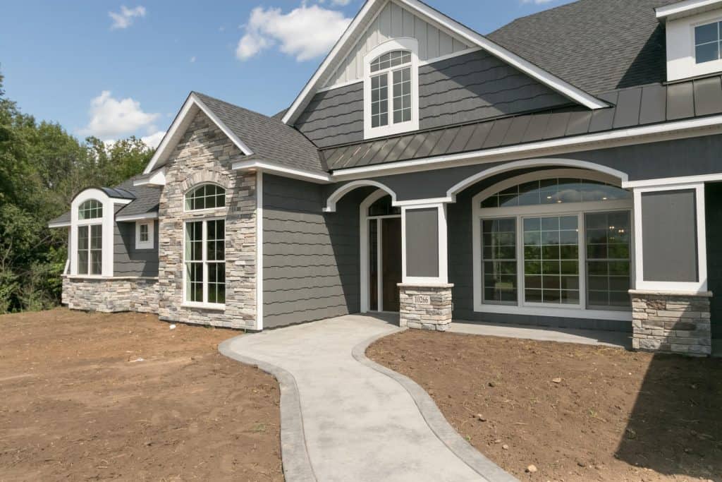 Modern residential house with custom concrete walkway and stone accents, Project Gallery.
