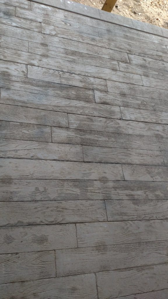 Modern wood-look concrete flooring for outdoor patios and walkways.