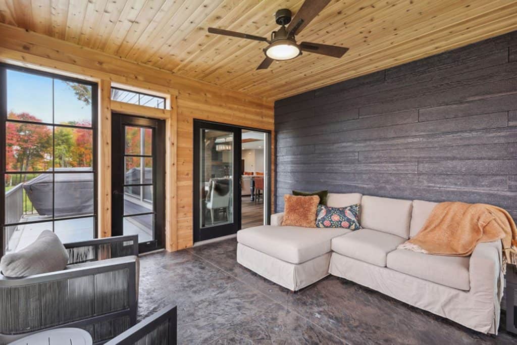 Cozy screened porch with sectional and wood ceiling