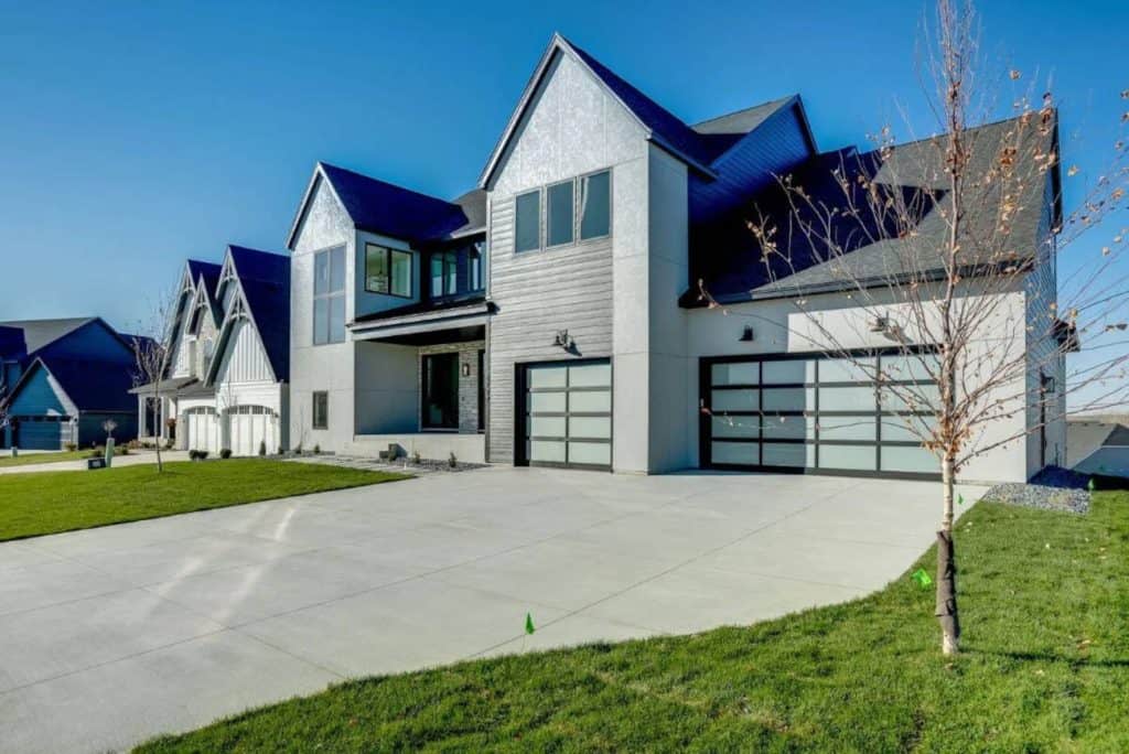 Modern suburban houses with large garages and driveways