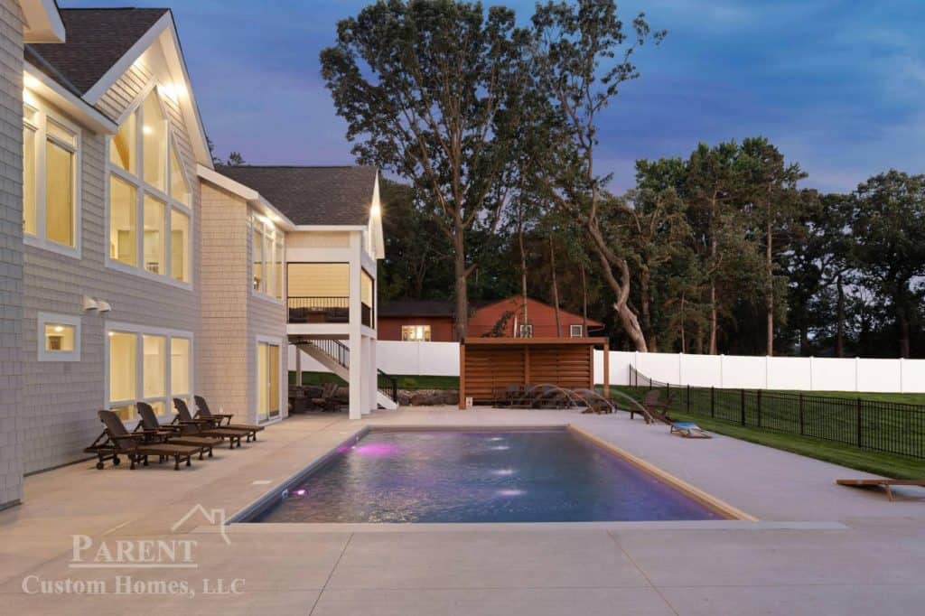 Two-story home with illuminated backyard pool
