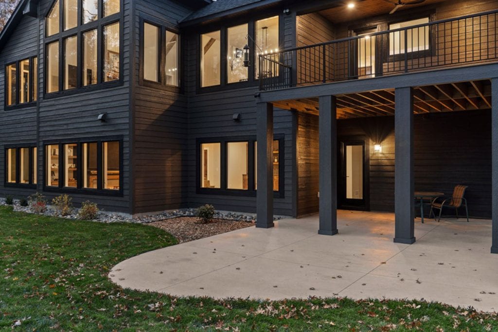 Modern two-story home with covered patio at dusk