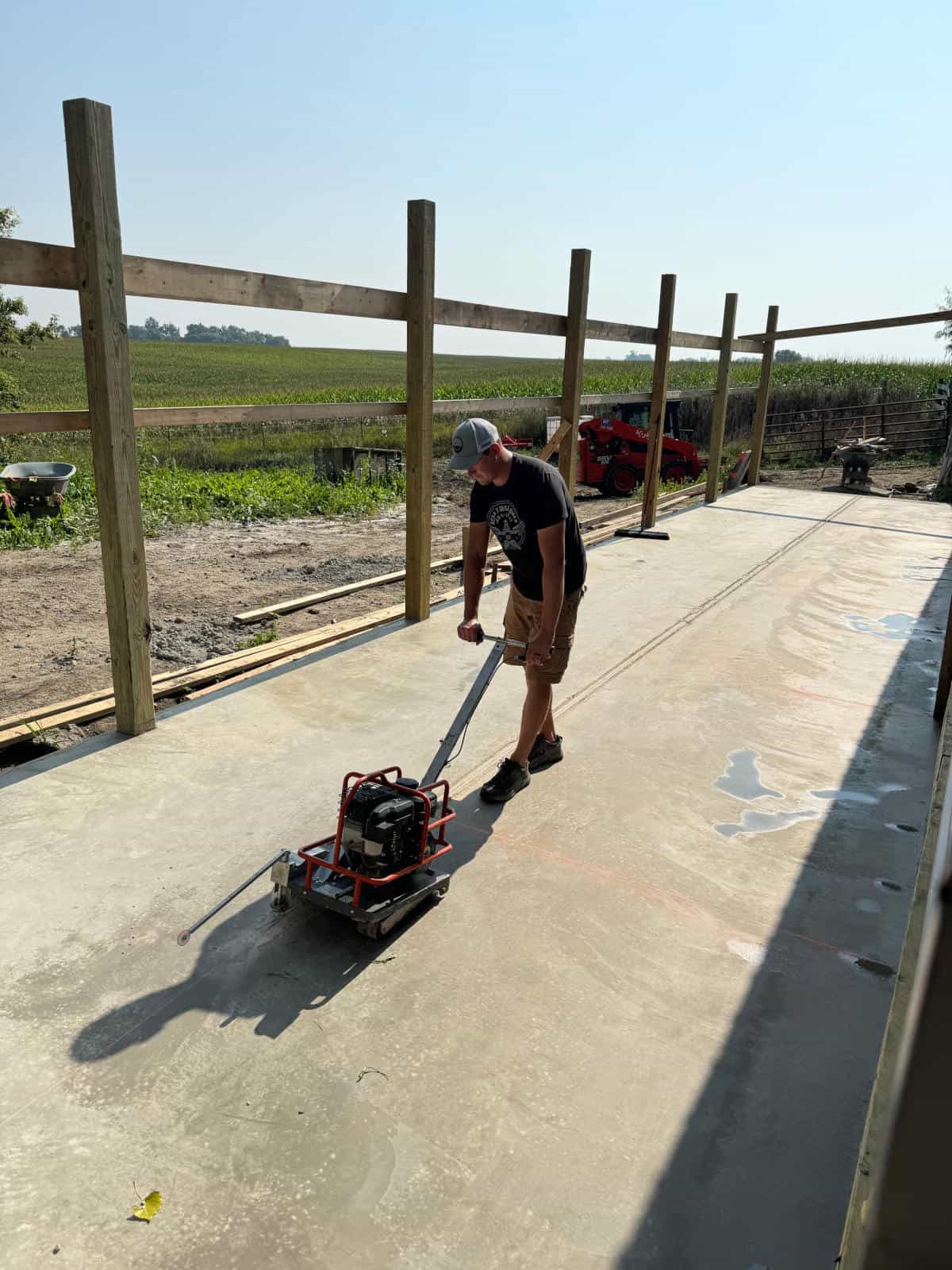 Man using Concrete saw on concrete slab.